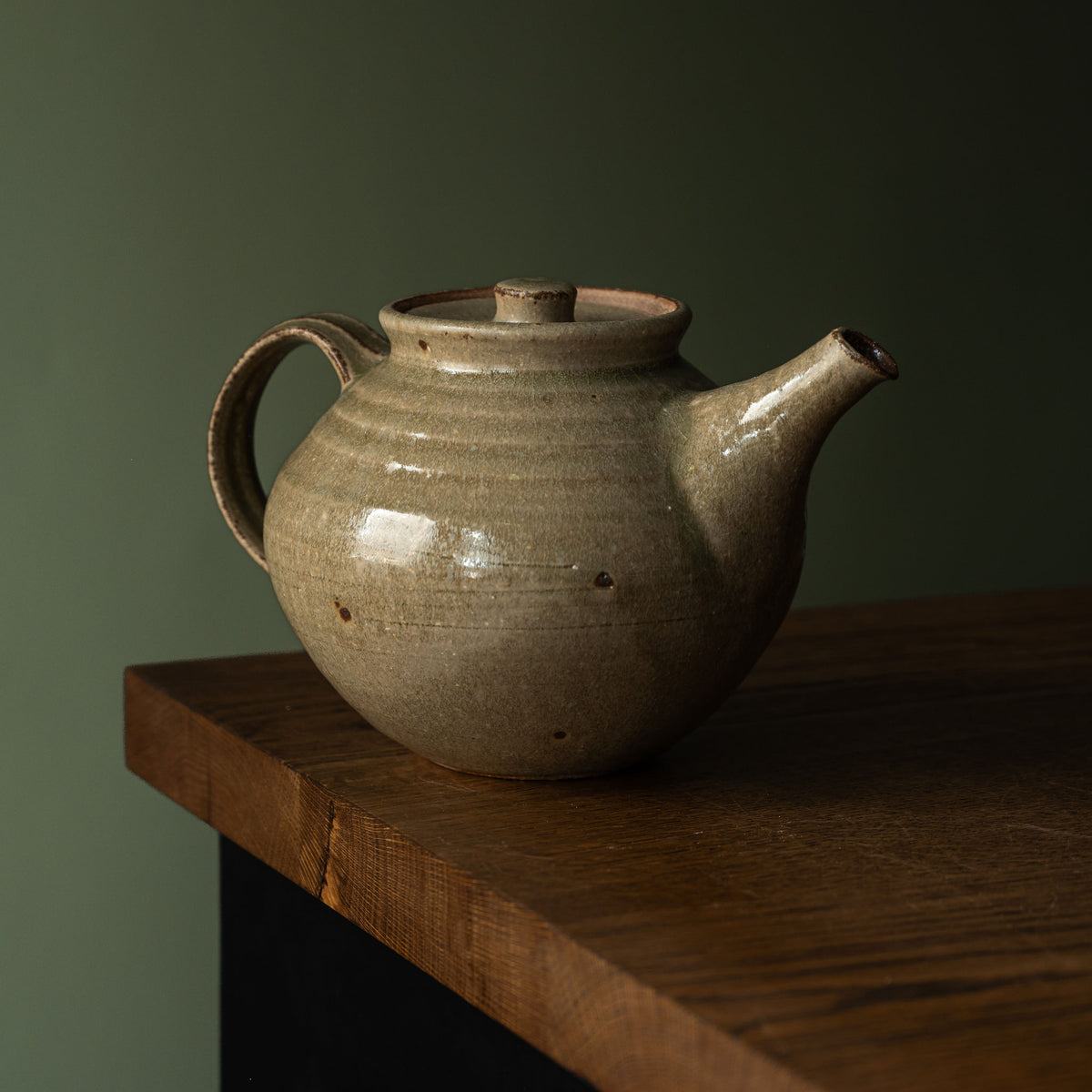 Leach Pottery handmade ceramic teapot in Ash green glaze with a rounded body, side pouring handle and spout. 