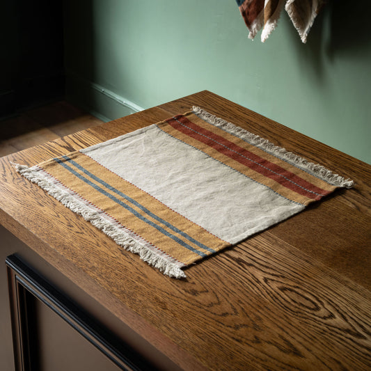 Libeco Belgian linen Hillside striped napkin or placemat on a wooden surface 