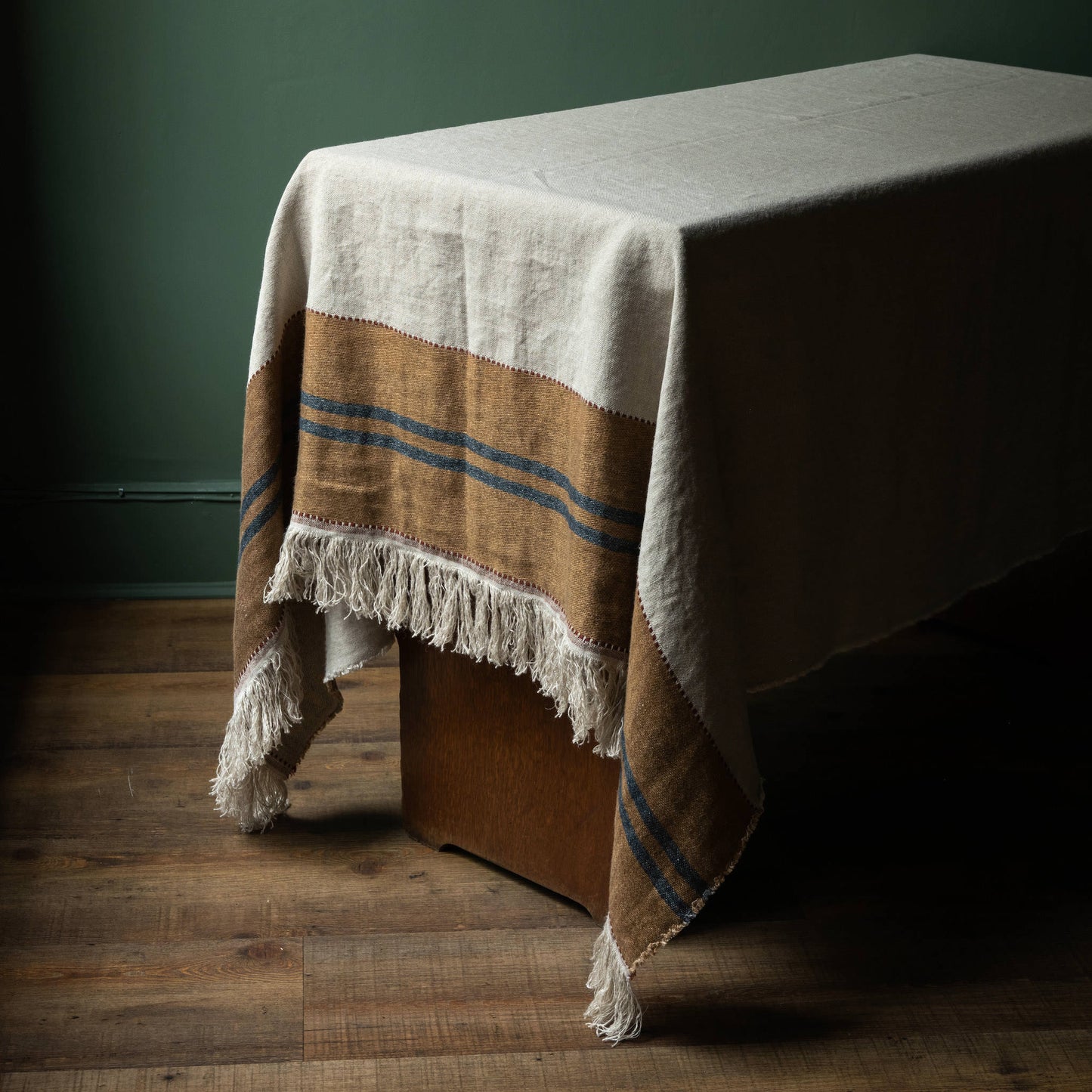 Libeco Belgian Linen Hillside Table Throw. Natural Flax colour with old & leather coloured band and dark blue stripes and fringed edge. 