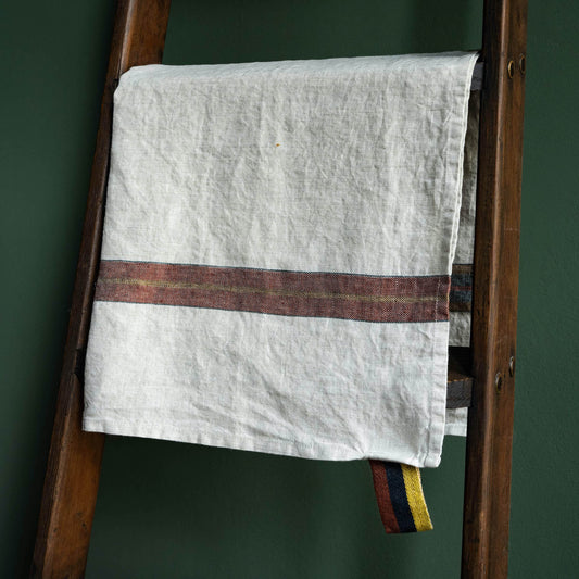 Libeco Linen "Leather Stripe" Dock Tea Towel hanging on a wooden ladder 