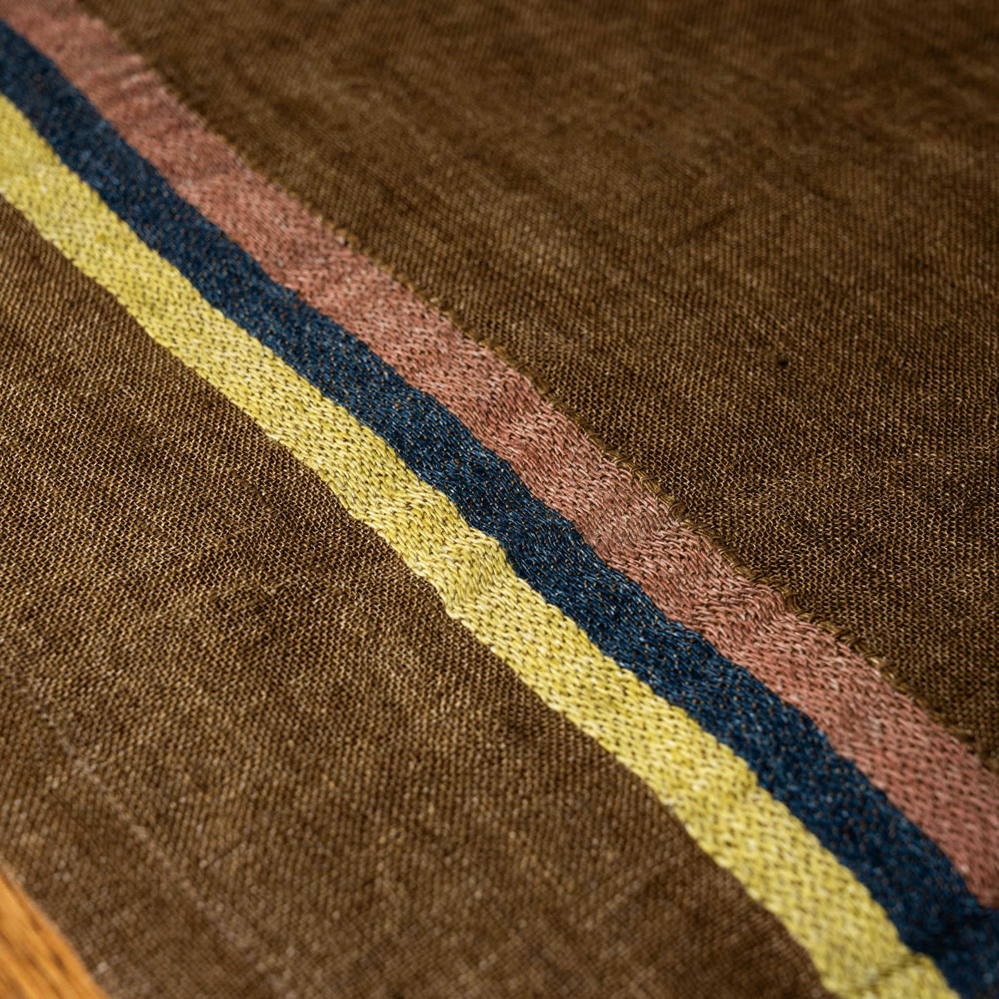 Close-up of brown Libeco Virginia napkin with multicoloured stripes