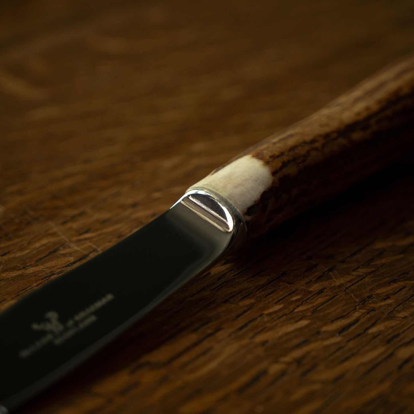 Close up of McLean of Braemar antler handle and steel blade join of the steak knife