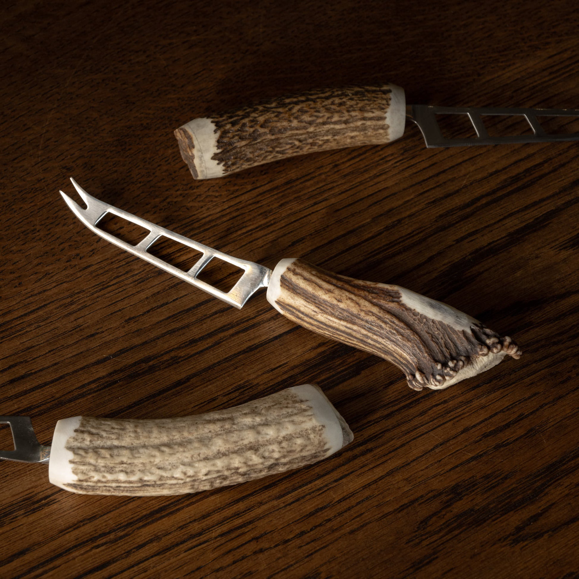 Assortment of soft cheese knives showing variation of antler handles