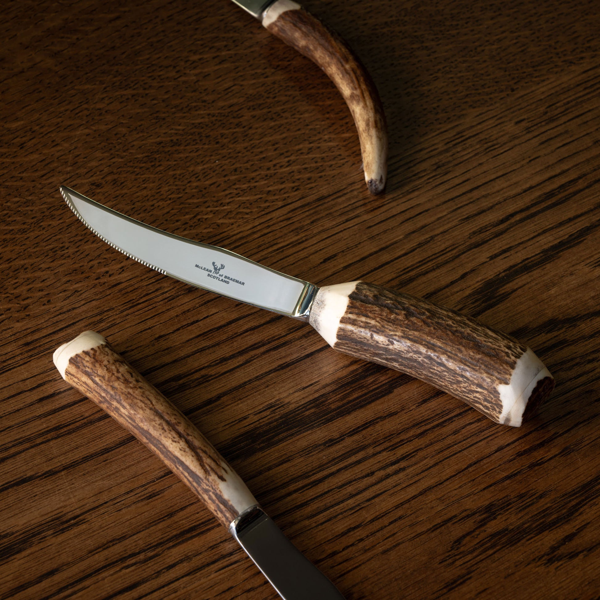 Assortment of McLean of Braemar steak knives showing variation of antler handles