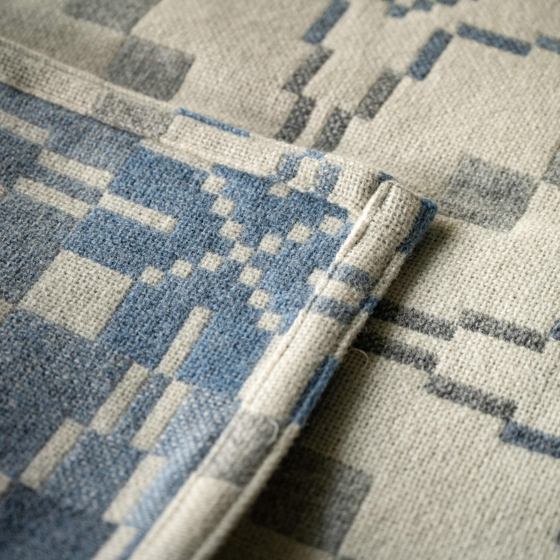 Close-up of both sides of Melin Tregwynt Vintage Star Cynefin Welsh Blanket  