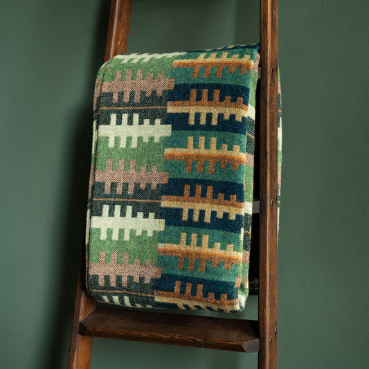 Melin Tregwynt Welsh wool blanket. Forest design, using stylised trees in tones of green & brown 