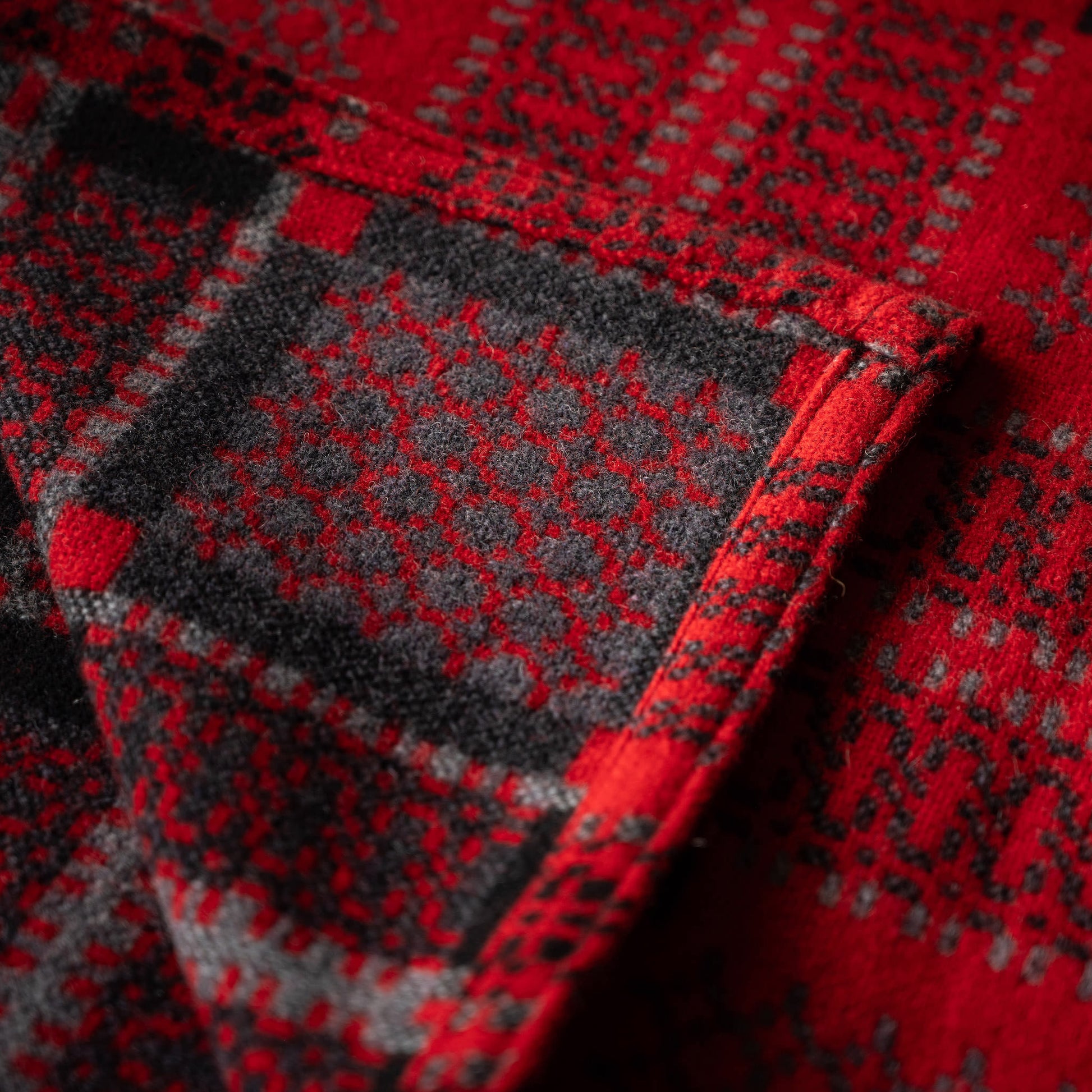 Close-up of Melin Tregwynt Draig Knot Garden Welsh Blanket  showing both sides of the doublecloth design