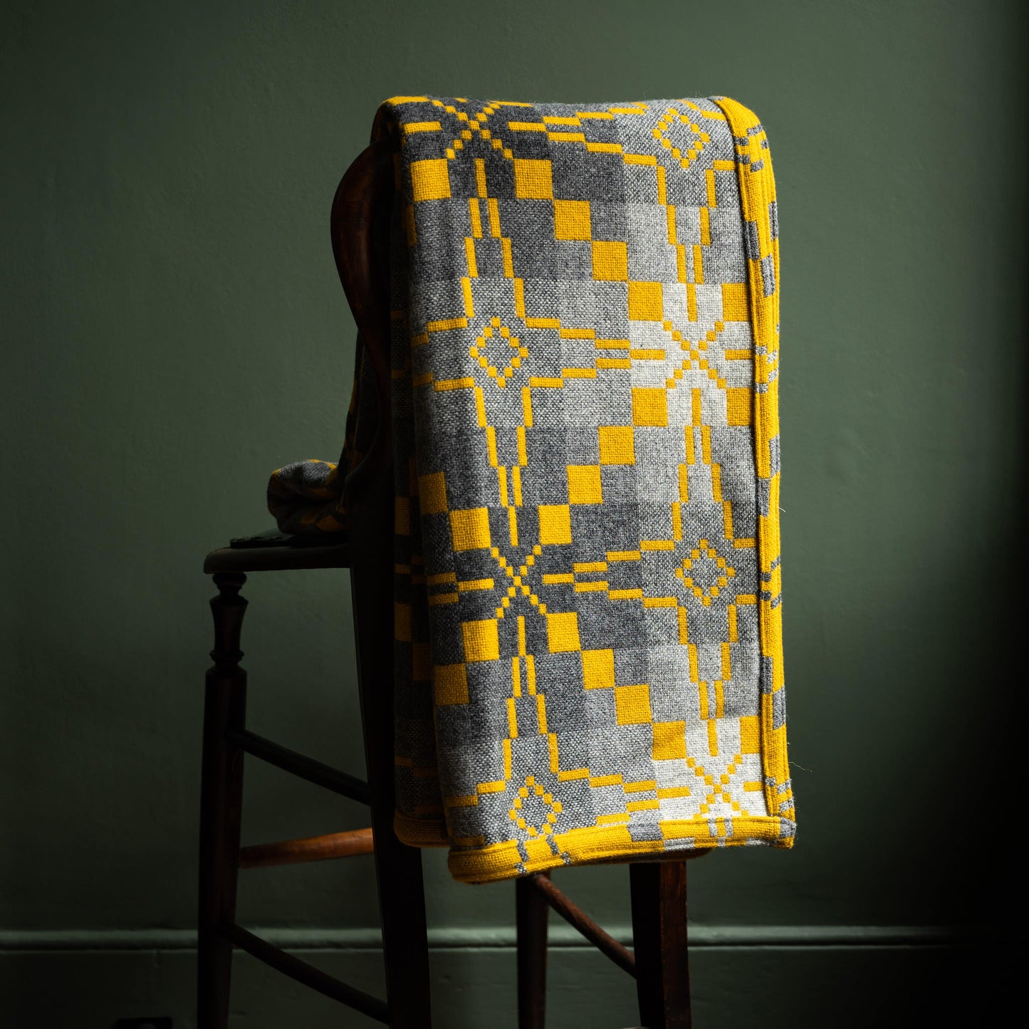 Reverse side of Melin Tregwynt Vintage Star Welsh Blanket in Gorse colourway.