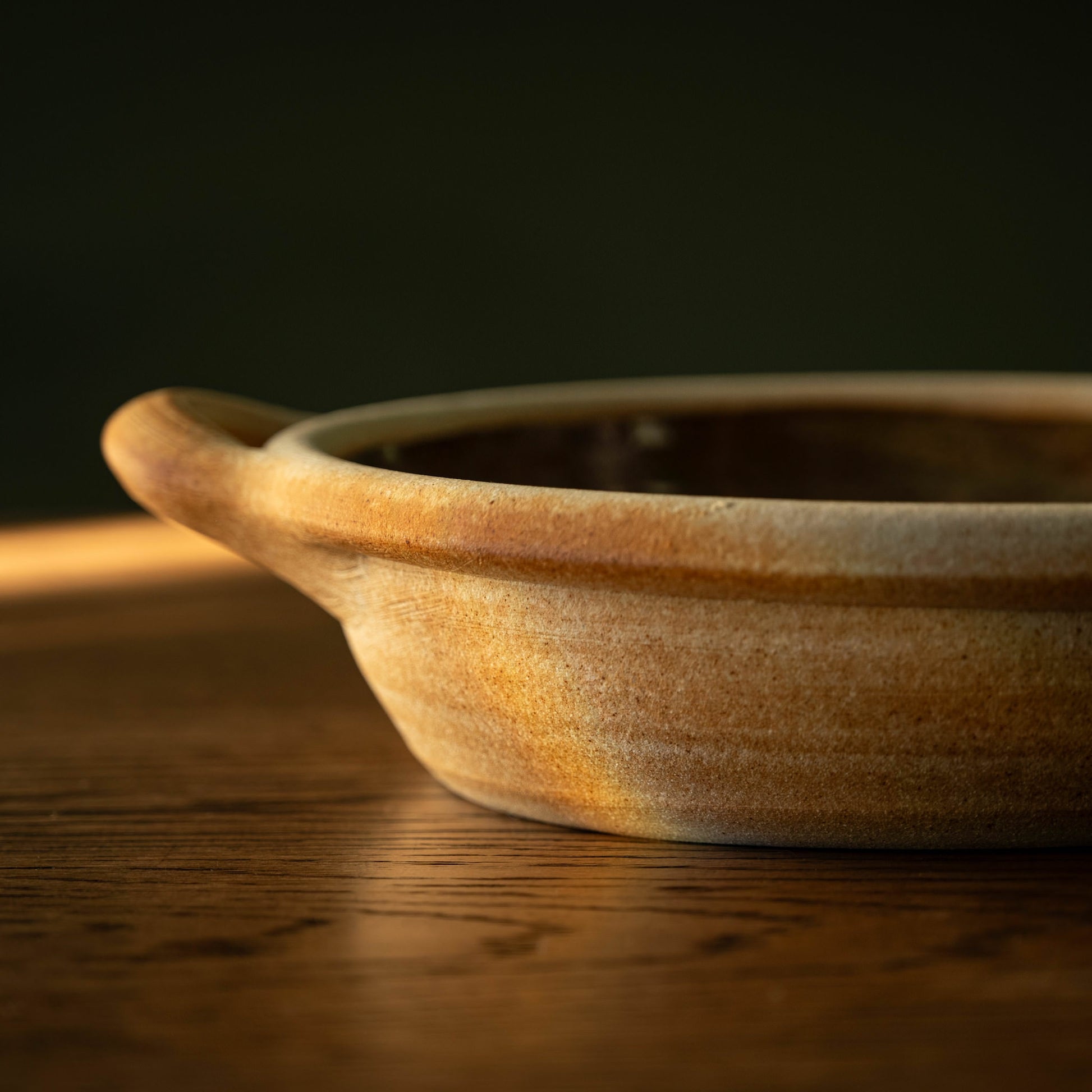 Muchelney Pottery medium shallow baking dish side view and handle. 