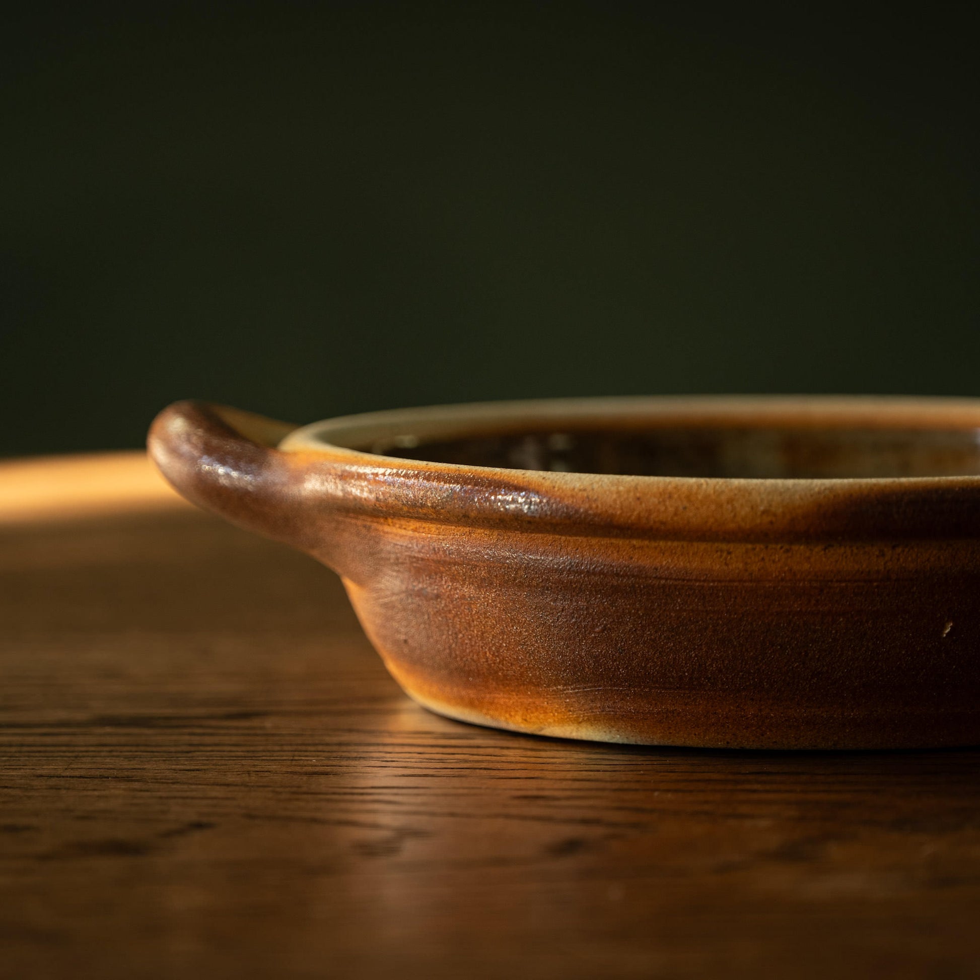 Muchelney Pottery small shallow baking dish side depth and handle. 