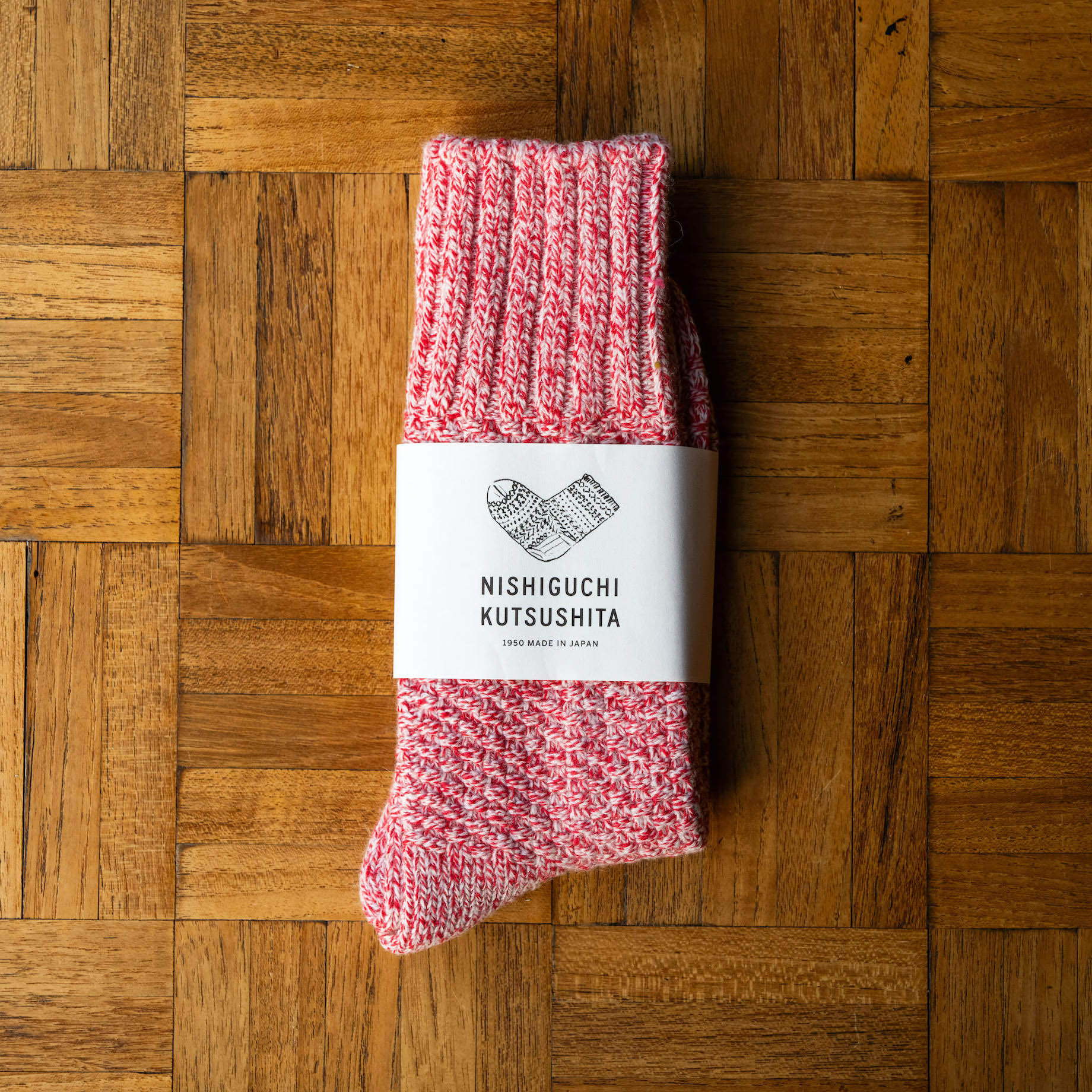 Nishiguchi Kutsushita Wool Boot Socks in Lobster Roll colour. With branded paper sleeve.