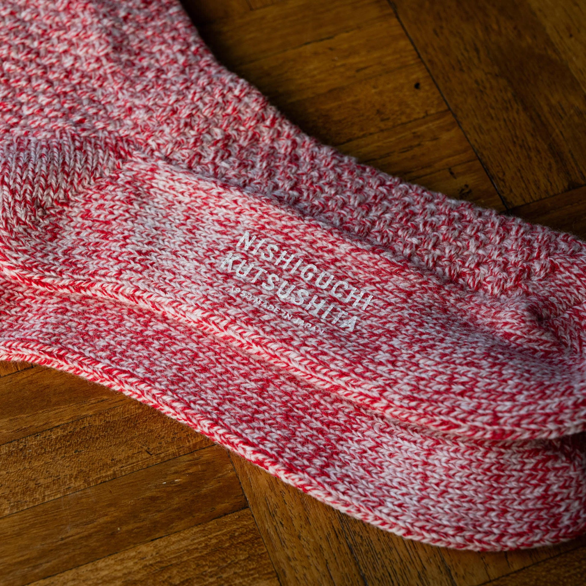 Nishiguchi Kutsushita Wool Boot Socks in Lobster Roll colour. Sole & logo detail.