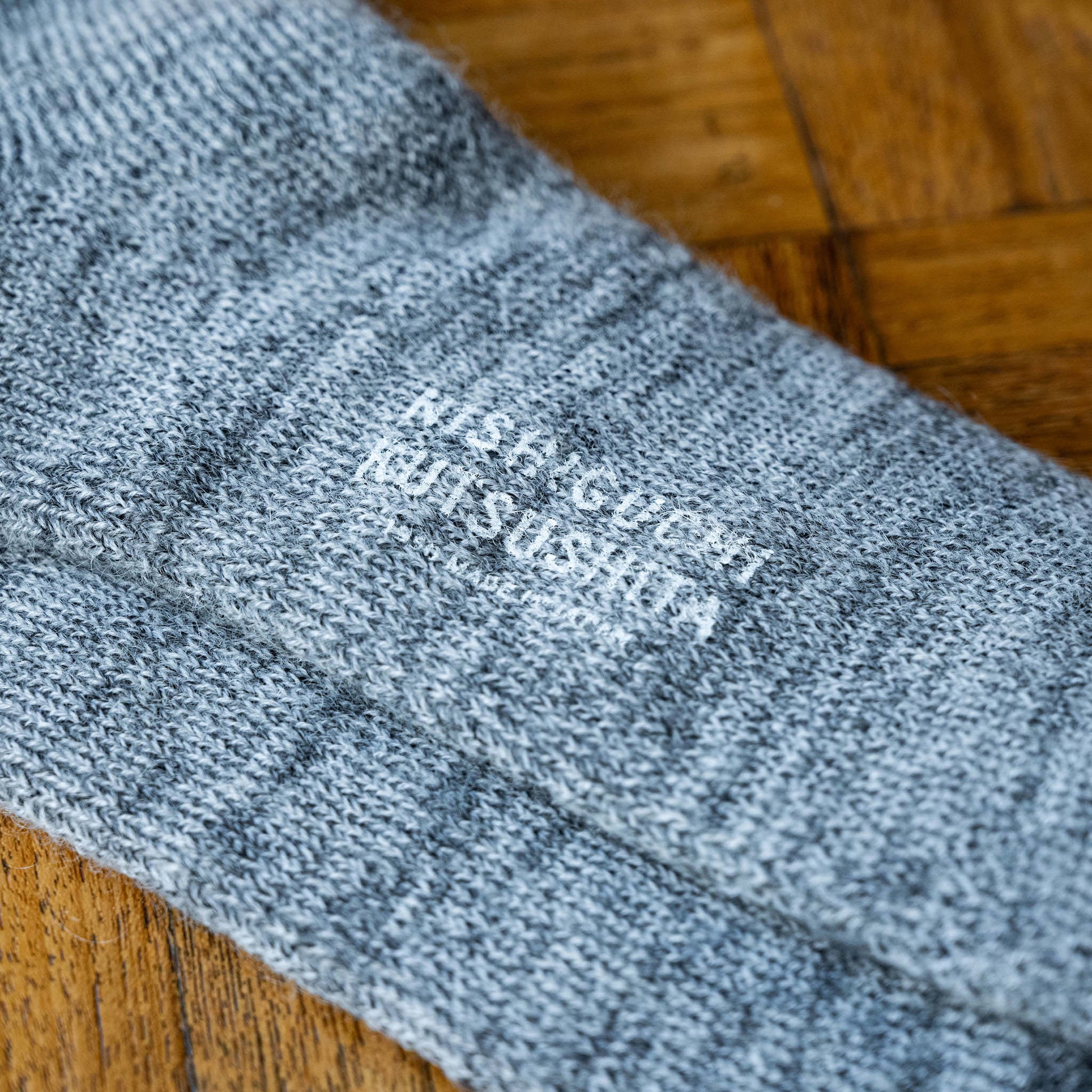 Grey sole of Nishiguchi Mohair & Wool sock with logo branding 