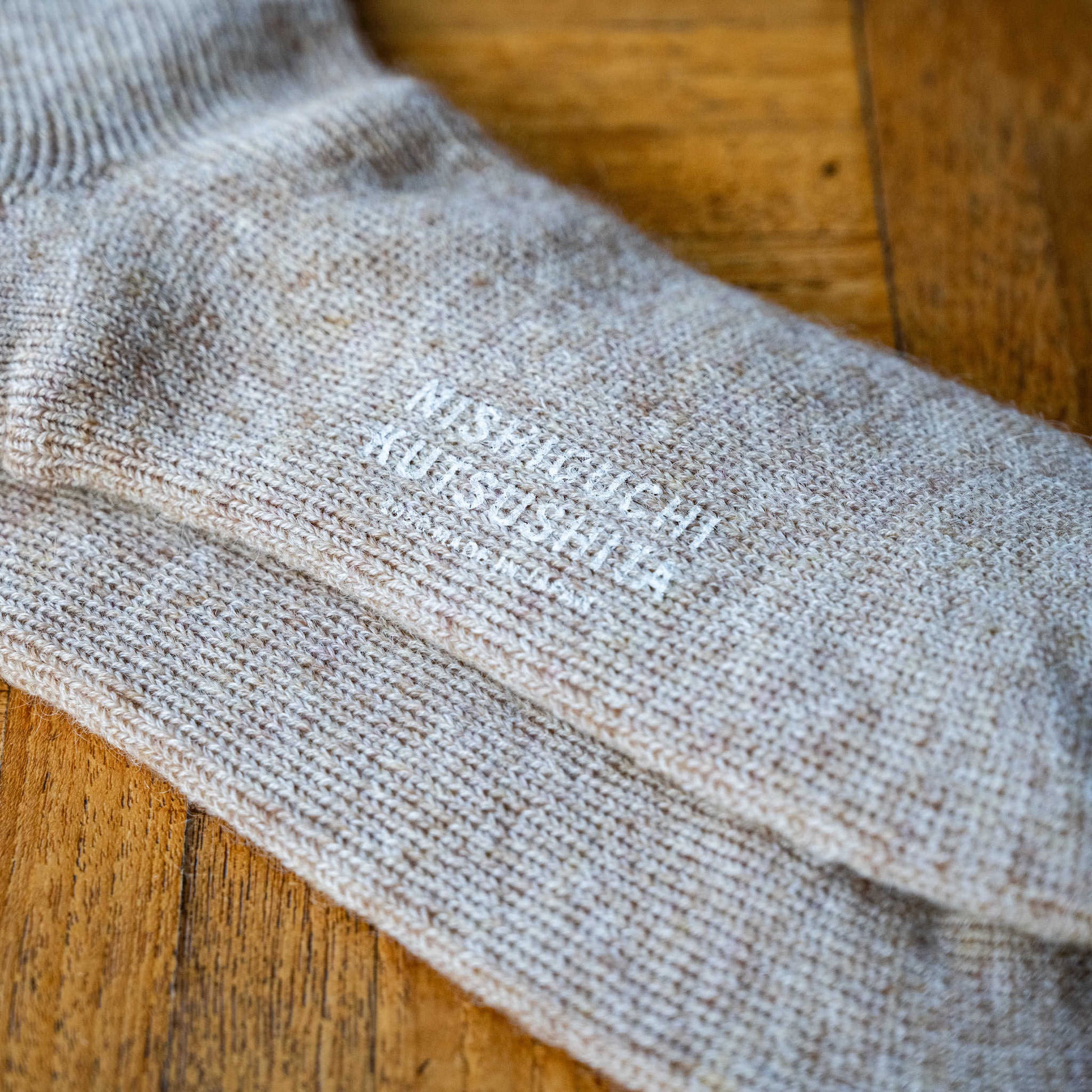Sole branding for Nishiguchi Kutsushita Trail Road mohair & wool socks