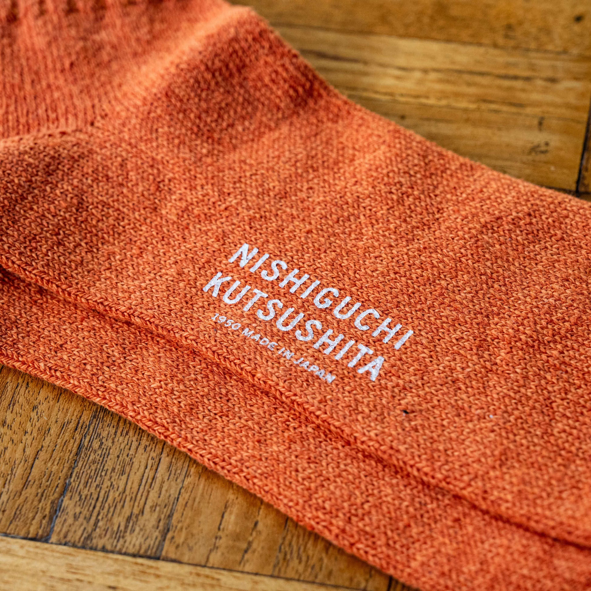 Amber Silk & Cotton Sock with 'Nishiguchi Kutsushita' branding on the sole