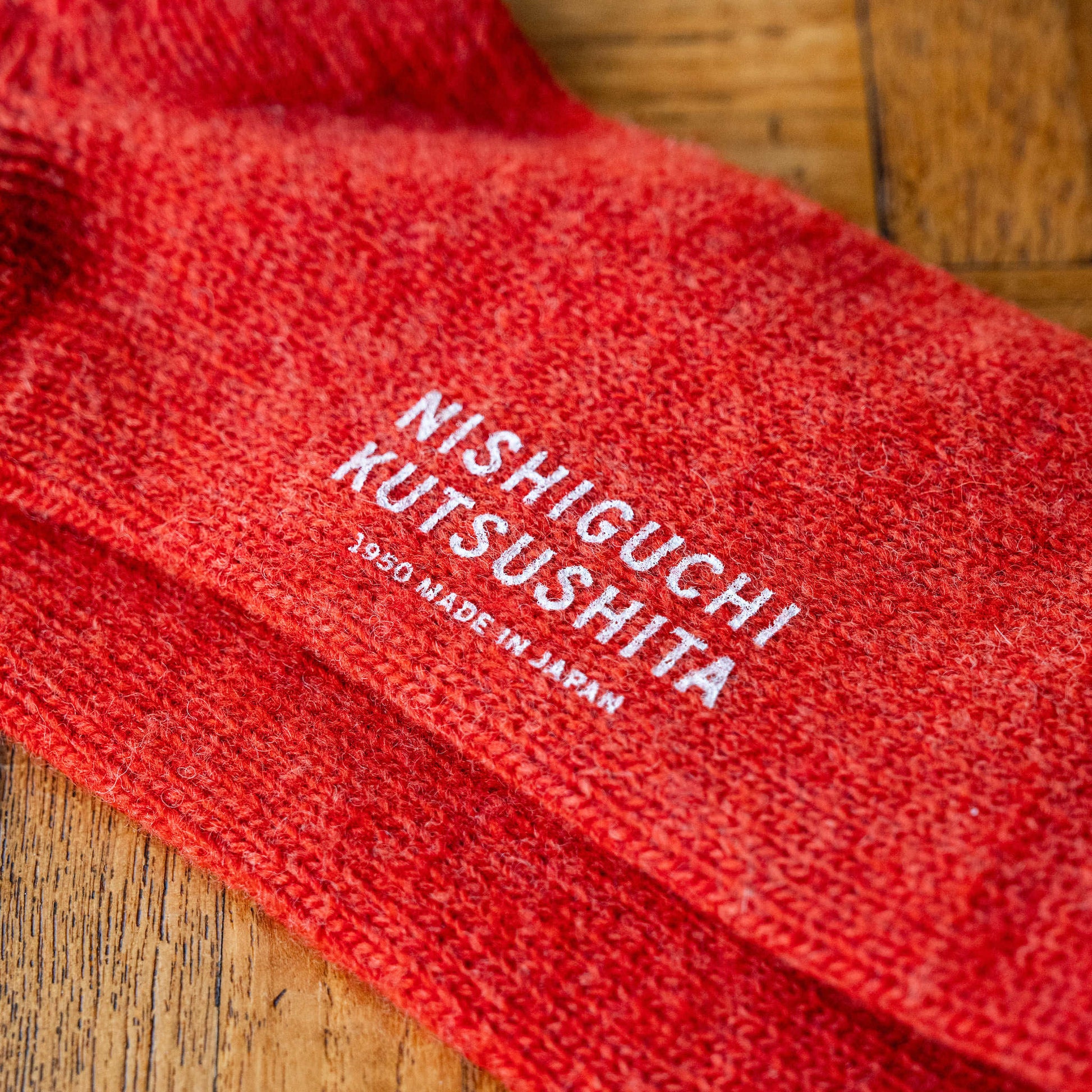 Shrine Red Wool Ribbed Socks with 'Nishiguchi Kutsushita' branding on the sole