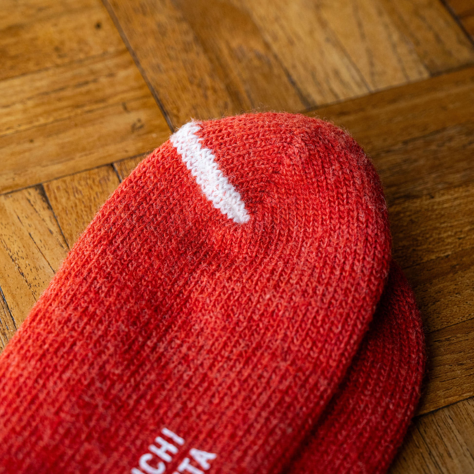 Nishiguchi Kutsushita Shrine Red Wool Ribbed Sock with a white stripe detail on the toe 