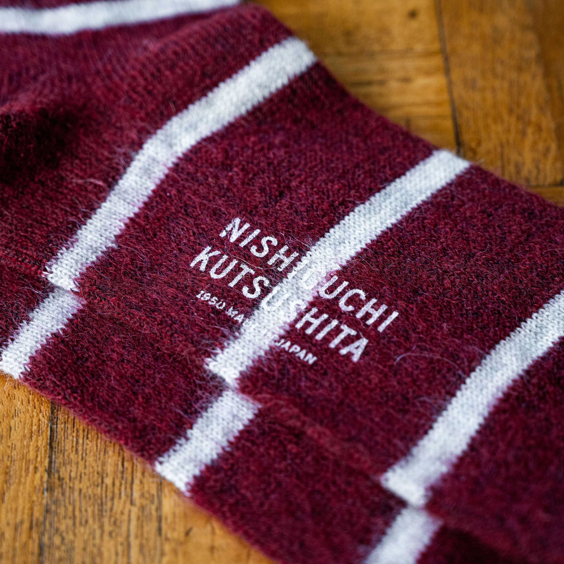 Wine coloured Mohair & Wool socks with white stripes and 'Nishiguchi kutsushita' branding on sole