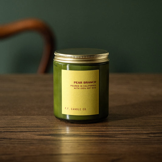 PF Candle Co "Pear Branch" scented candle in a green glass jar with a gold lid 