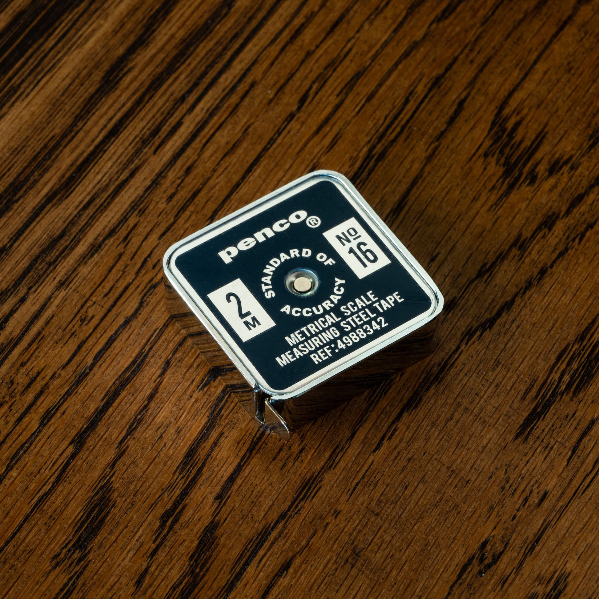 Penco Navy measuring tape on a wooden surface