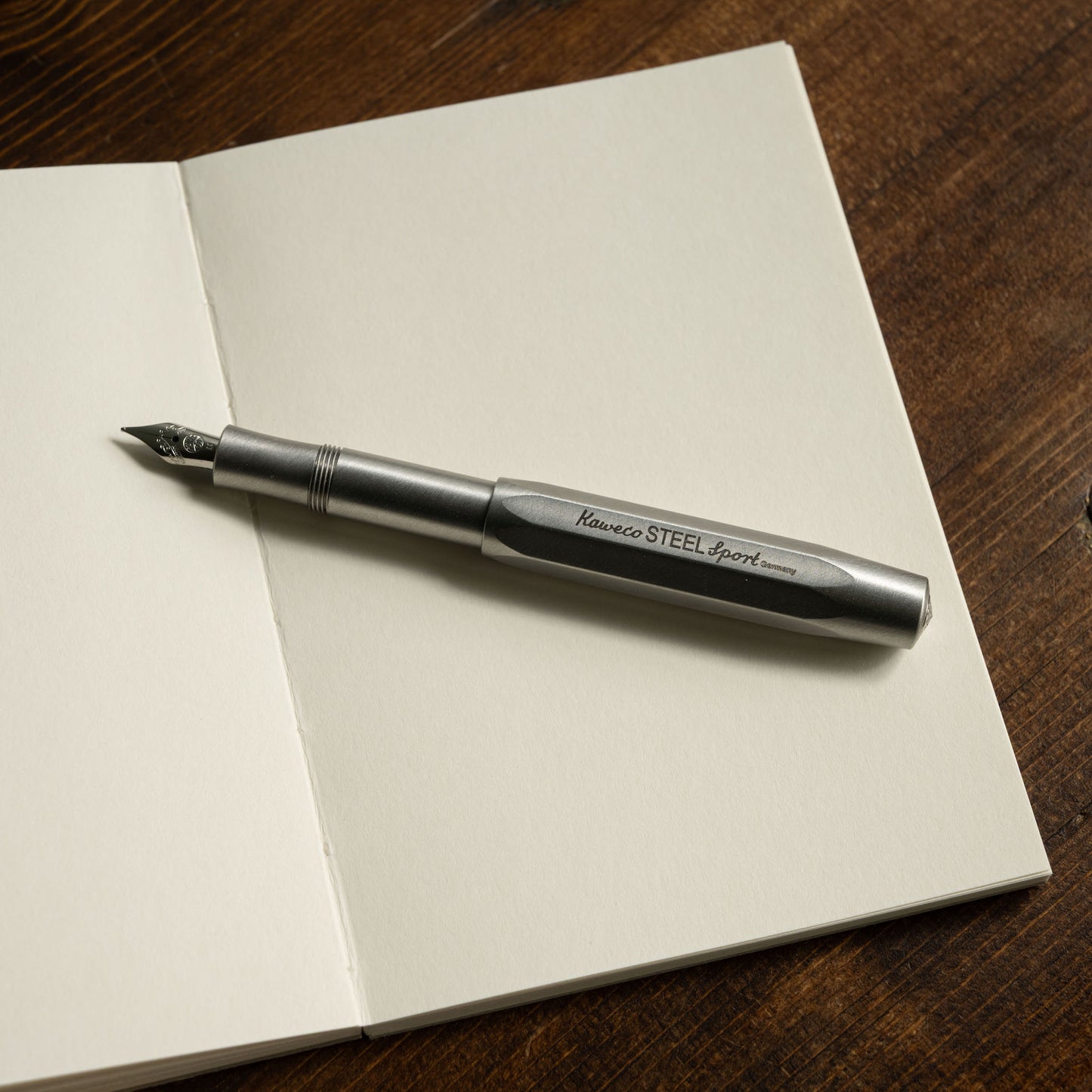 Pith Kabosu Sketchbook open showing blank 200gsm paper & a Kaweco Steel Sport Pen