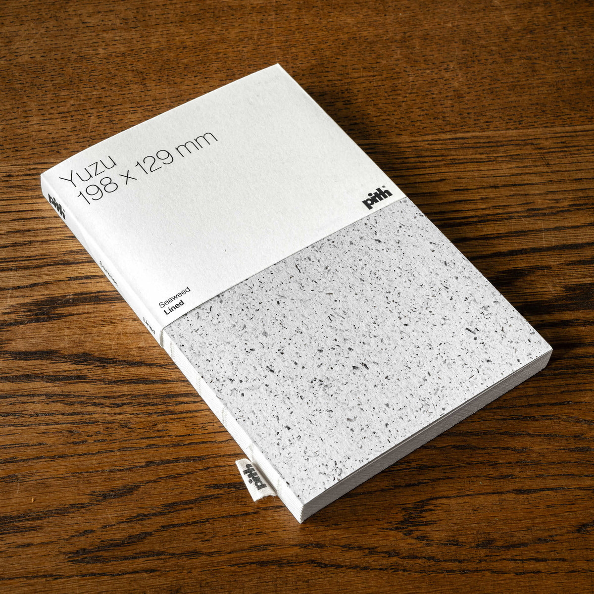Pith Supply Yuzu Lined notebook with a flexible Notpla seewead cover. The is 198mm x 129mm and the seaweed cover is light grey speckled.
