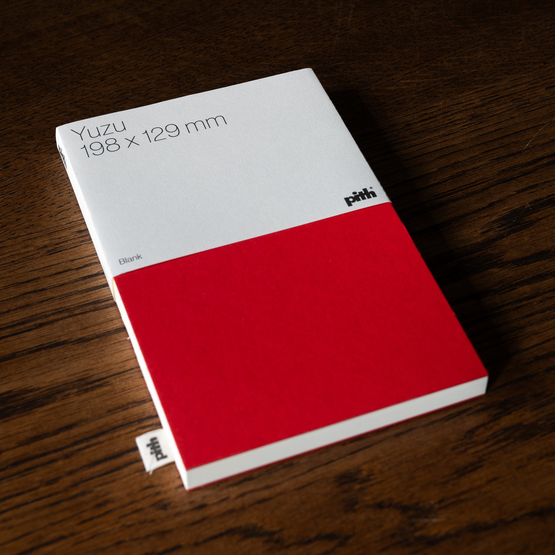 Pith Supply Yuzu Red Notebook with blank page layout. 