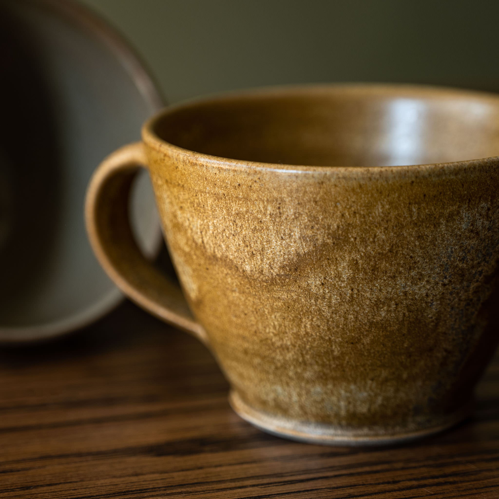 Pottery West Stoneware Curved Mug Ochre Glaze Close Up 