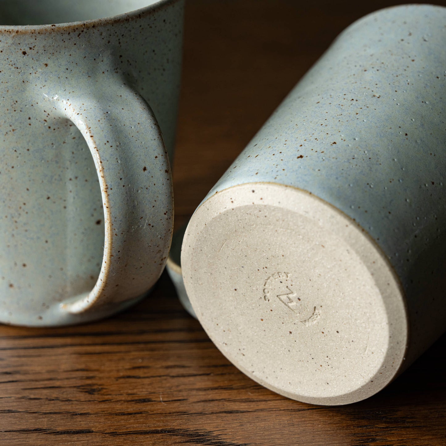 base of Pottery West powder blue tapered mug showing maker's mark
