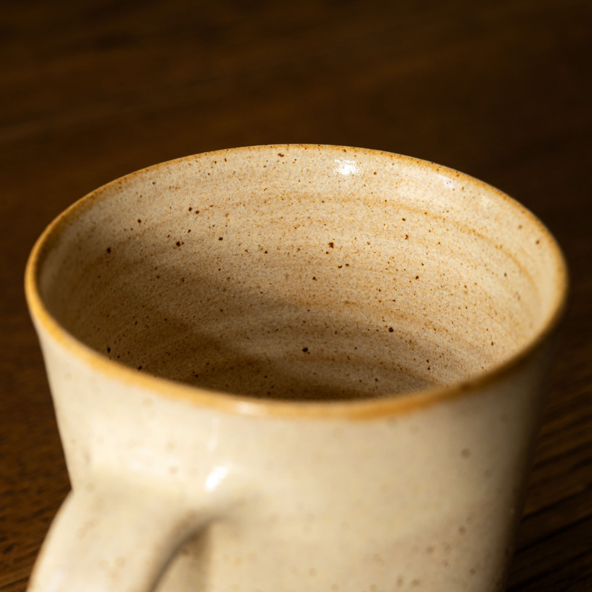Inside view of Pottery West Stoneware Tapered Mug in sand glaze. 