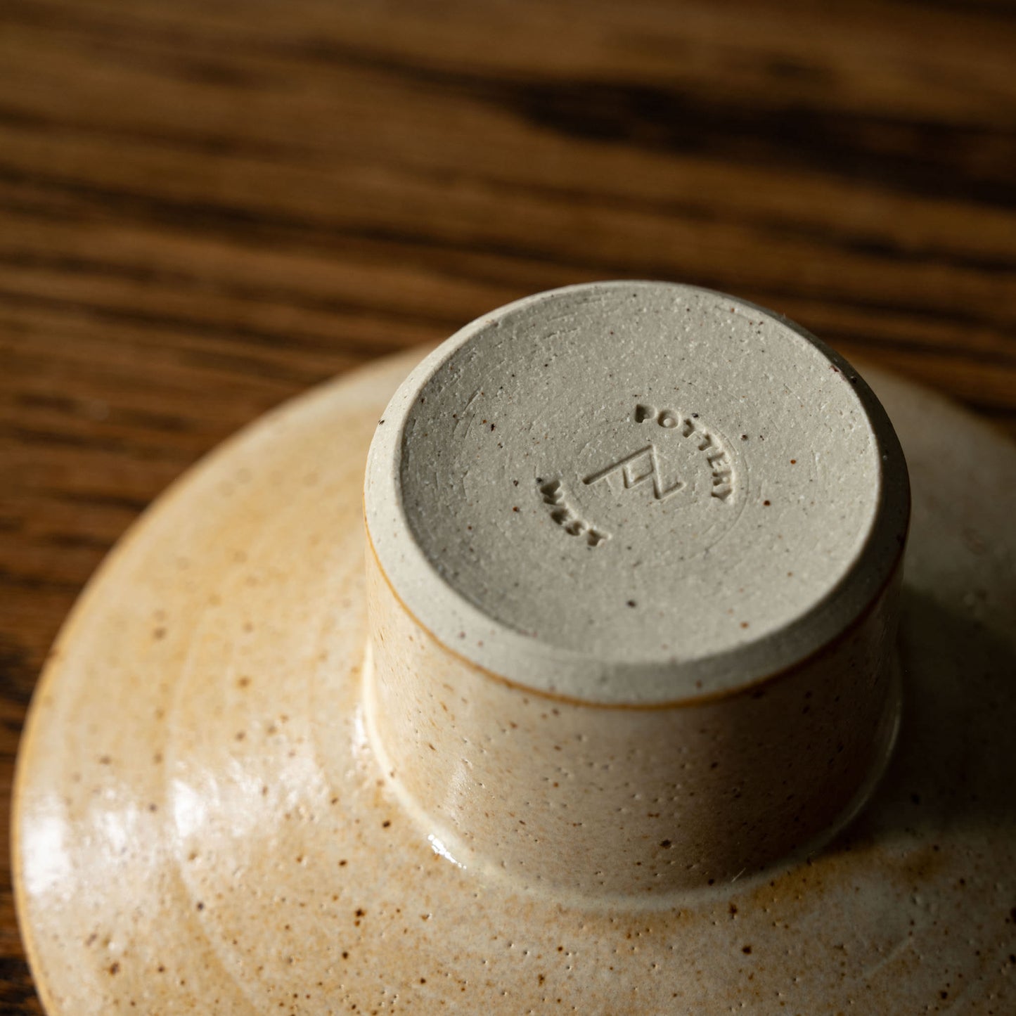 Base showing maker's mark of Pottery West standard candle holder in sand flecked stoneware