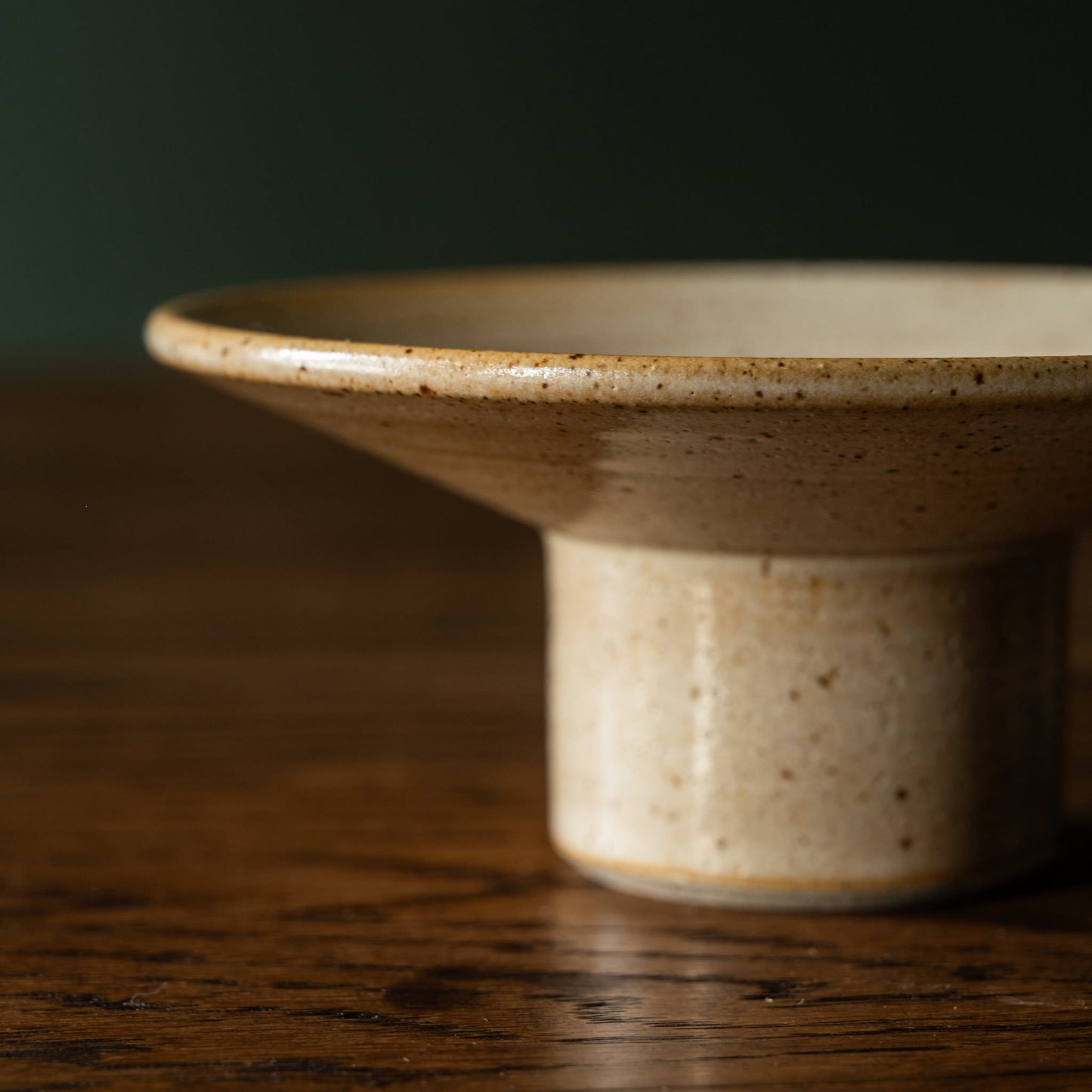 Side view of Pottery West standard candle holder in sand flecked stoneware