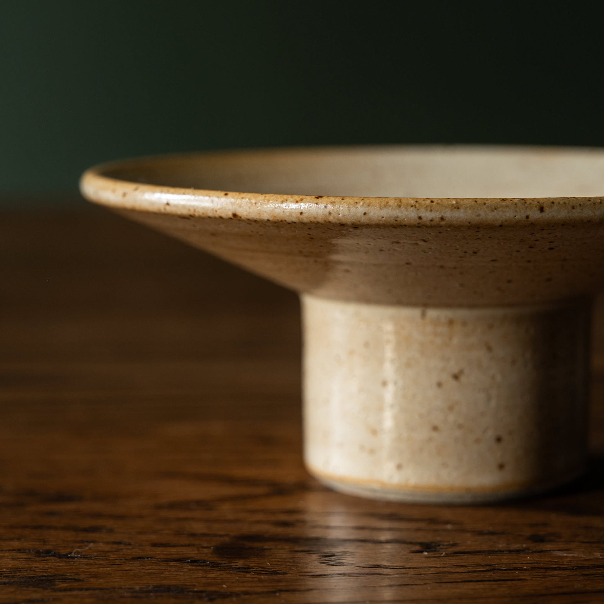 Side view of Pottery West standard candle holder in sand flecked stoneware