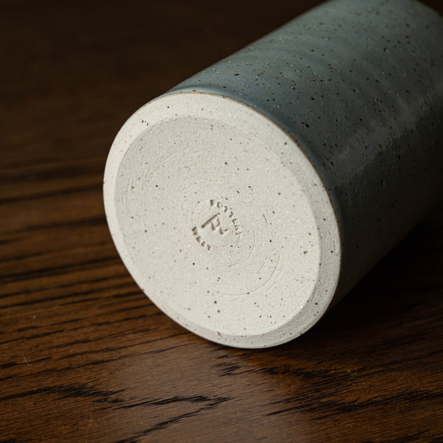 Base of the Pottery West powder blue stoneware pourer showing the maker's mark