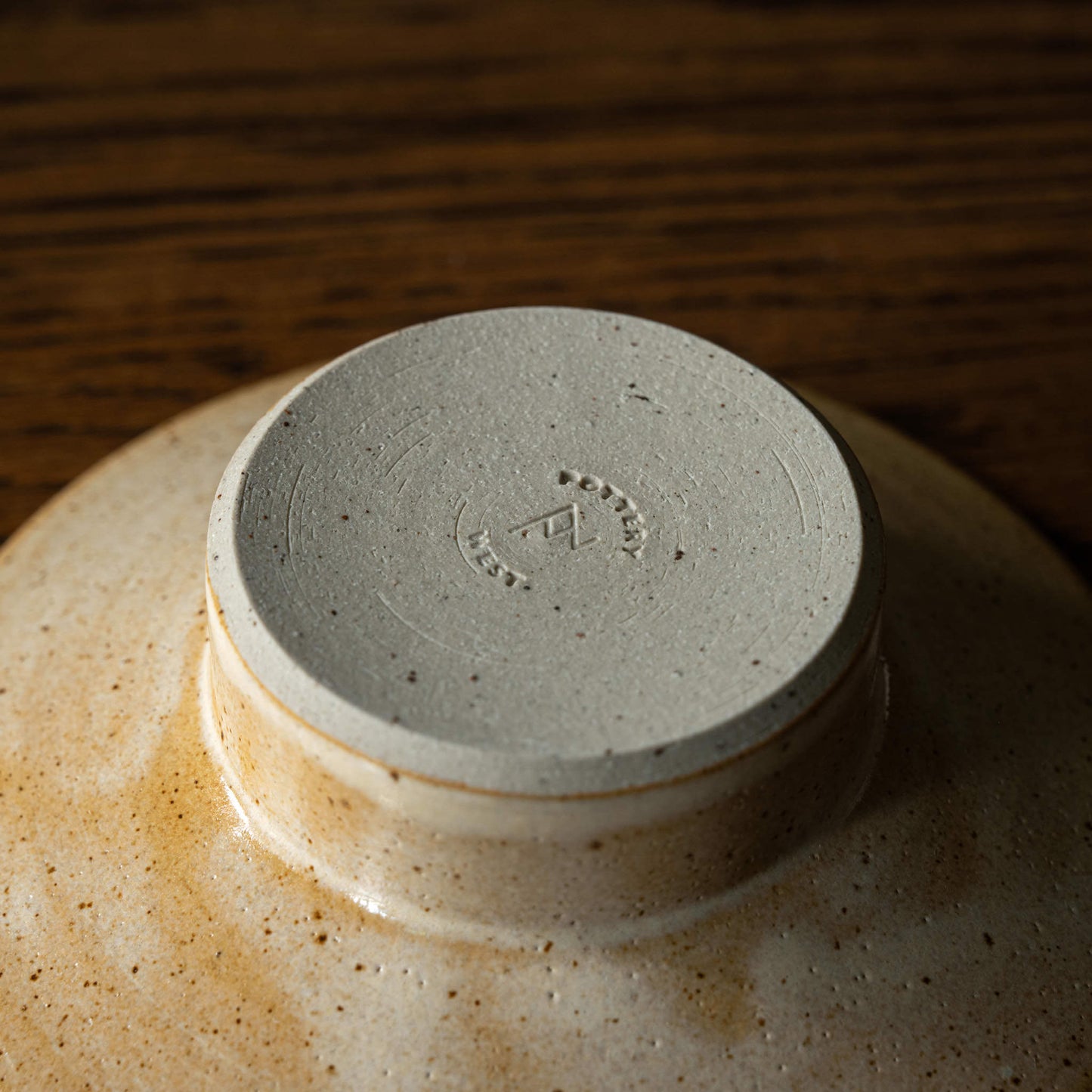 Base showing maker's mark of Pottery West stumpie candle holder