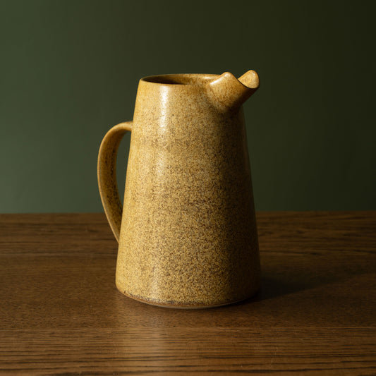 Pottery West stoneware jug in ochre glaze.