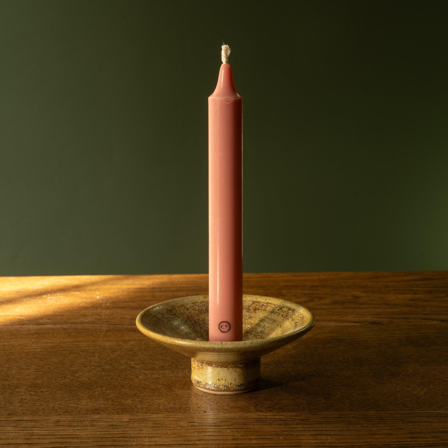 Pottery West stoneware dinner candle holder in ochre glaze with Carriere Freres taper candle.