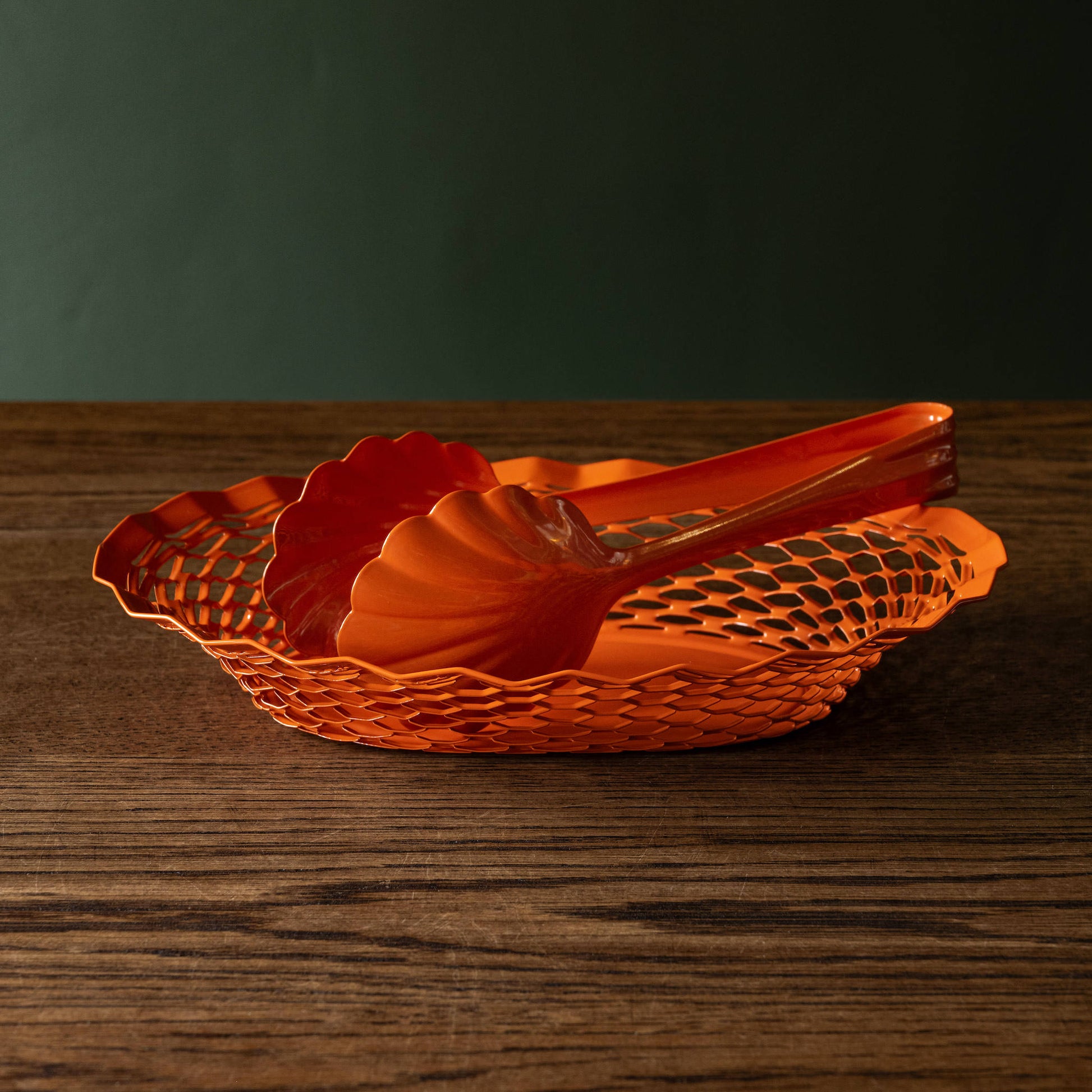 Orange Roger Orfevre scallop-shaped steel bakery tongs & matching orange steel oval basket 