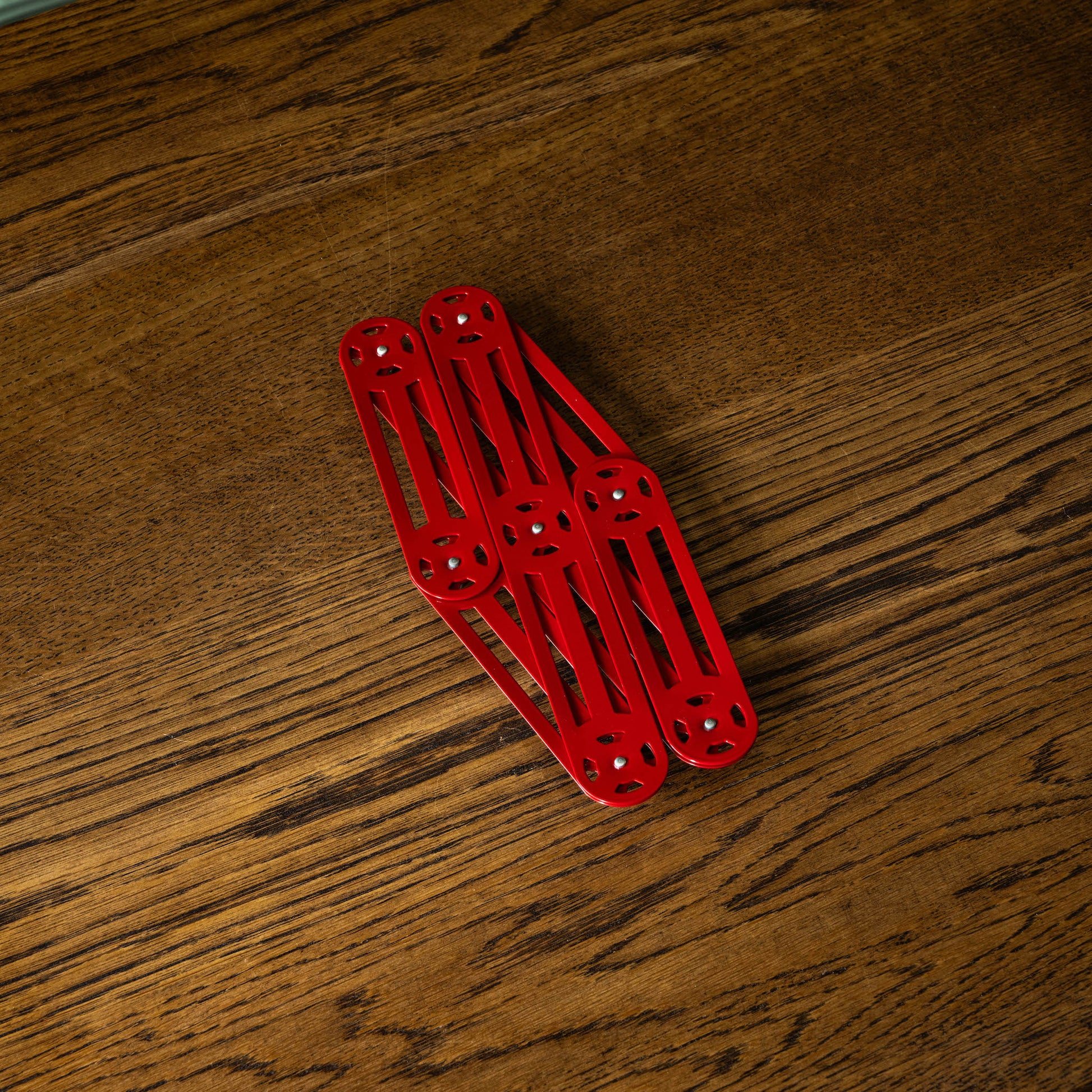 Stainless steel extending trivet fully closed in red 