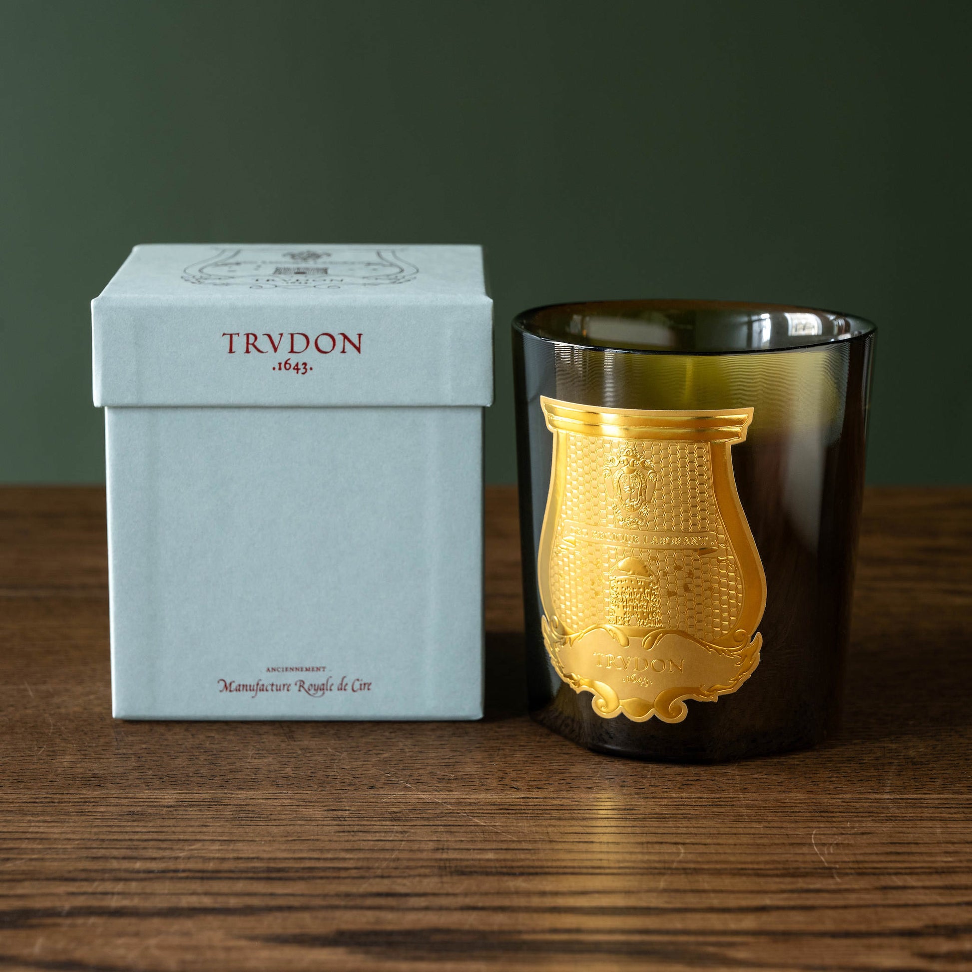 Trudon Joséphine scented candle and presentation box on a wooden surface