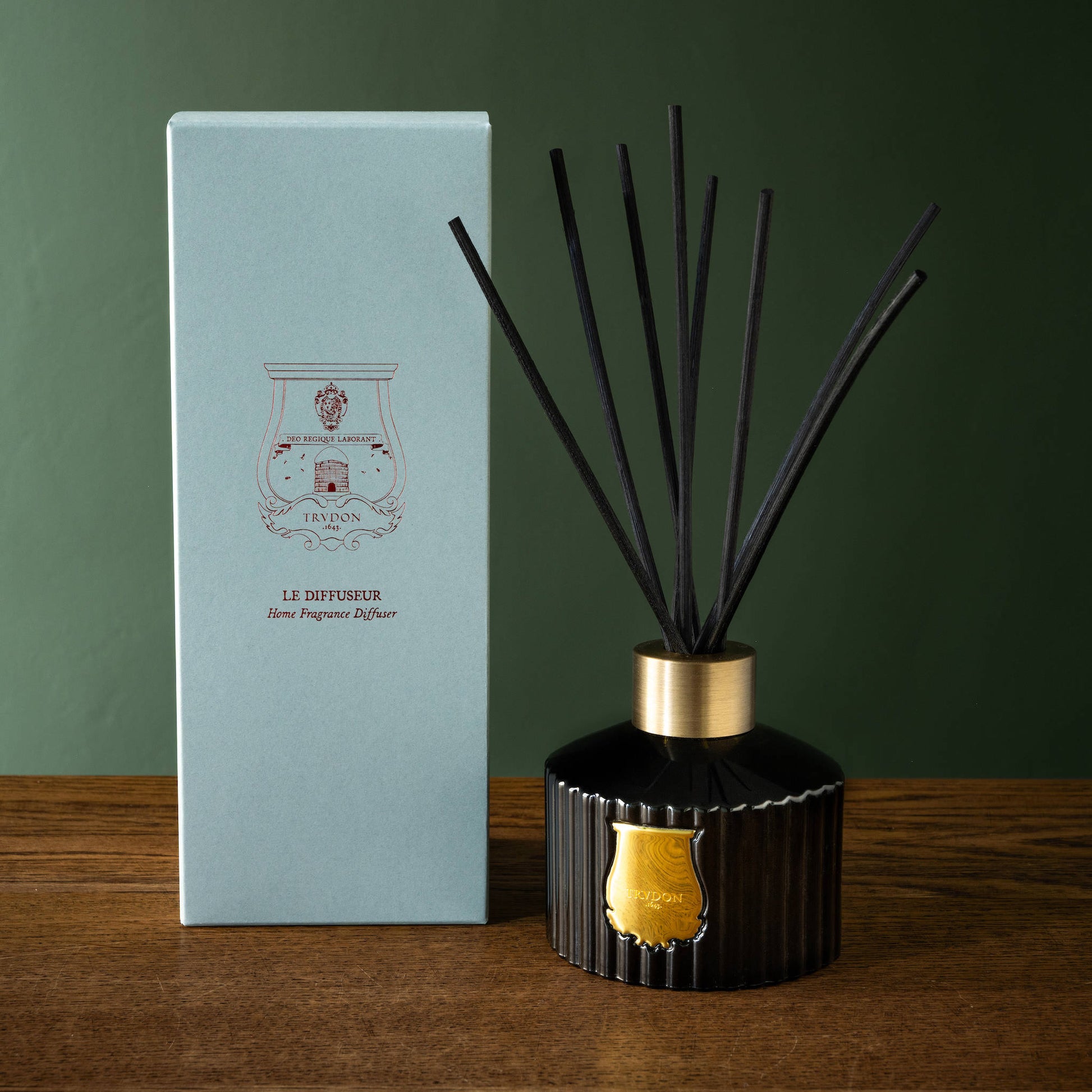 Trudon Gabriel Reed Diffuser next to its prerentation box on a wooden surface.