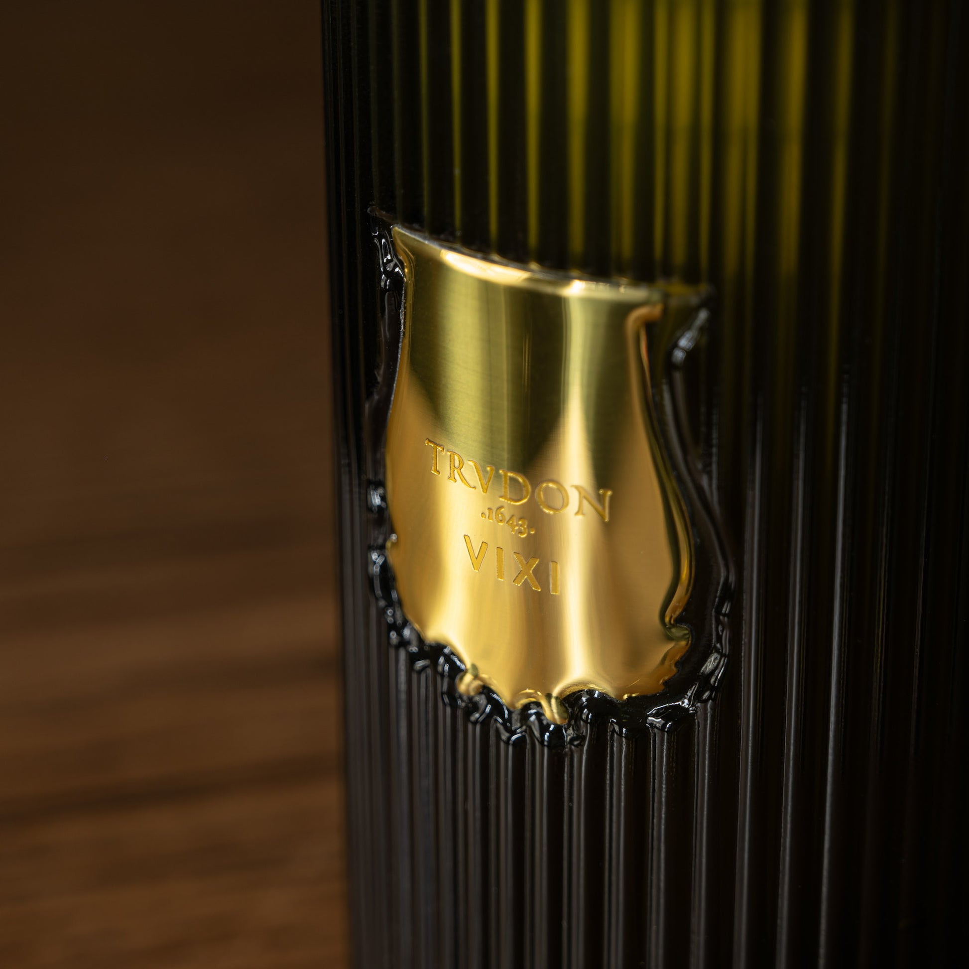 Close-up of Trudon logo on glass soap dispenser bottle 