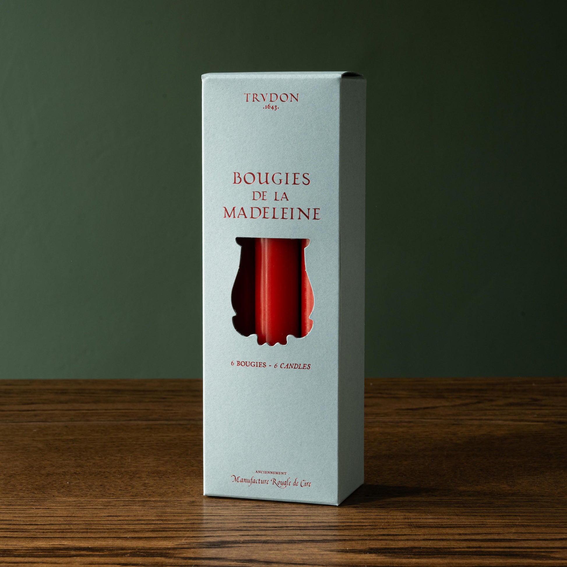 Box of six Trudon red brick taper candles 