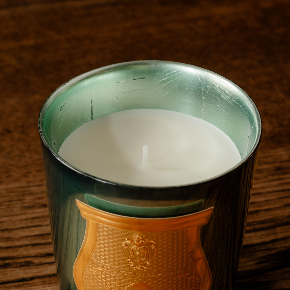 A close-up Trudon limited edition La Nuit des Glaces Fir scented 270g candle and cotton wick.
