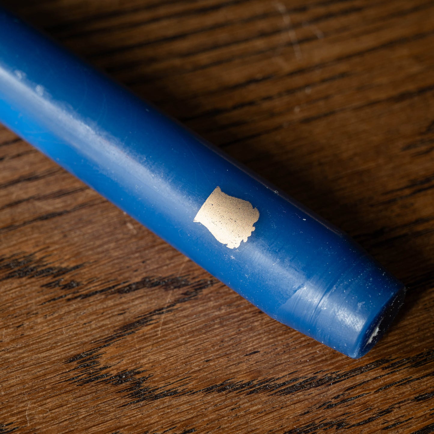 Close up of Trudon Madeleine Bleu Marine Taper candle.