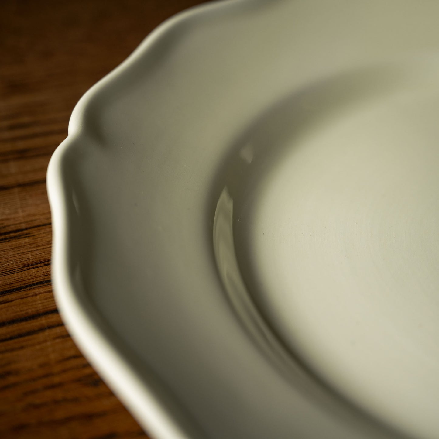 Close up of scalloped design on dinner plate rim