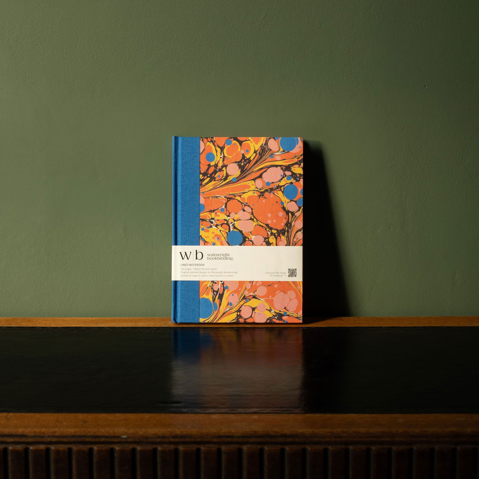 Wainwright Bookbinding notebook with colourful marbled design in orange, pink and royal blue 