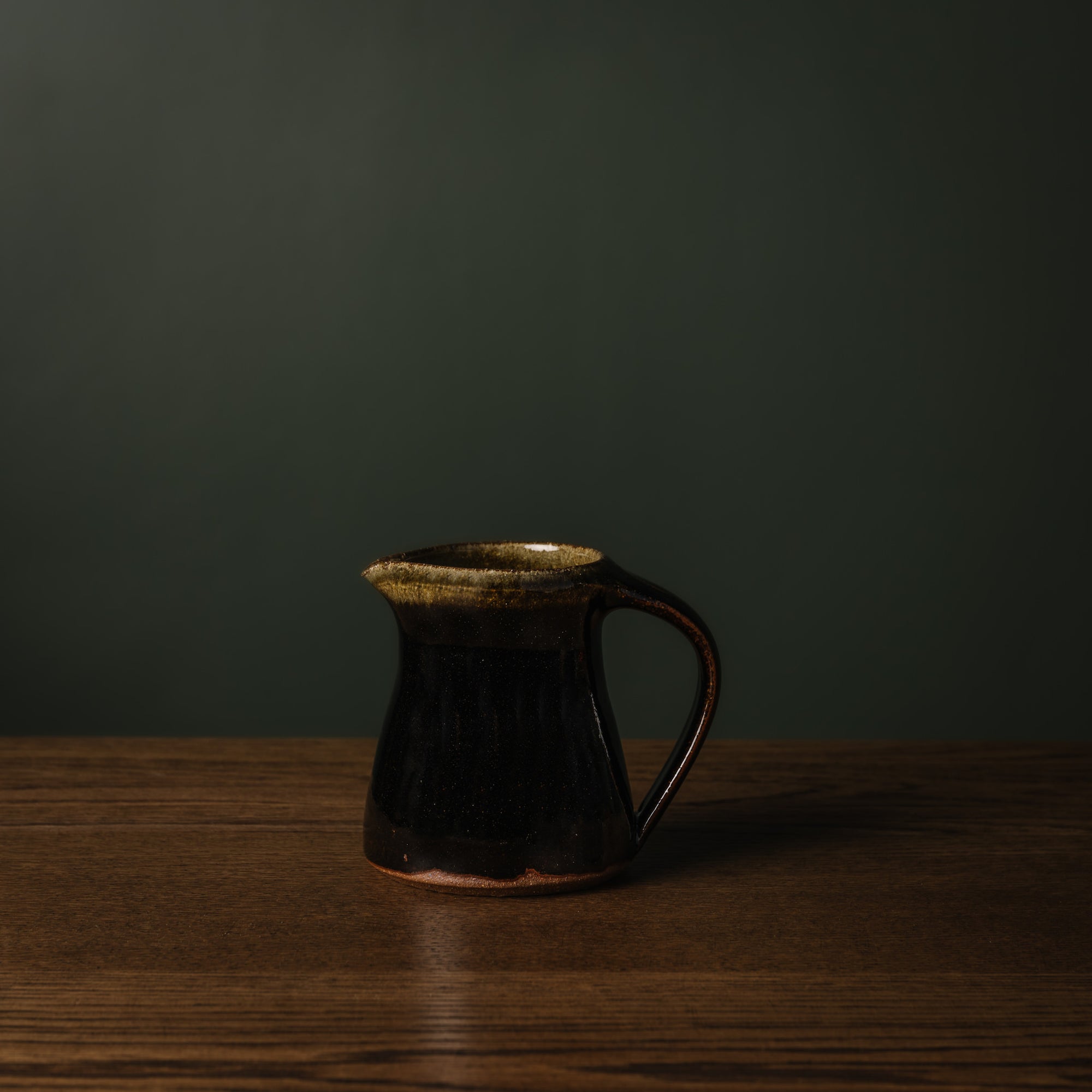 Leach Pottery small jug in tenmoku glaze